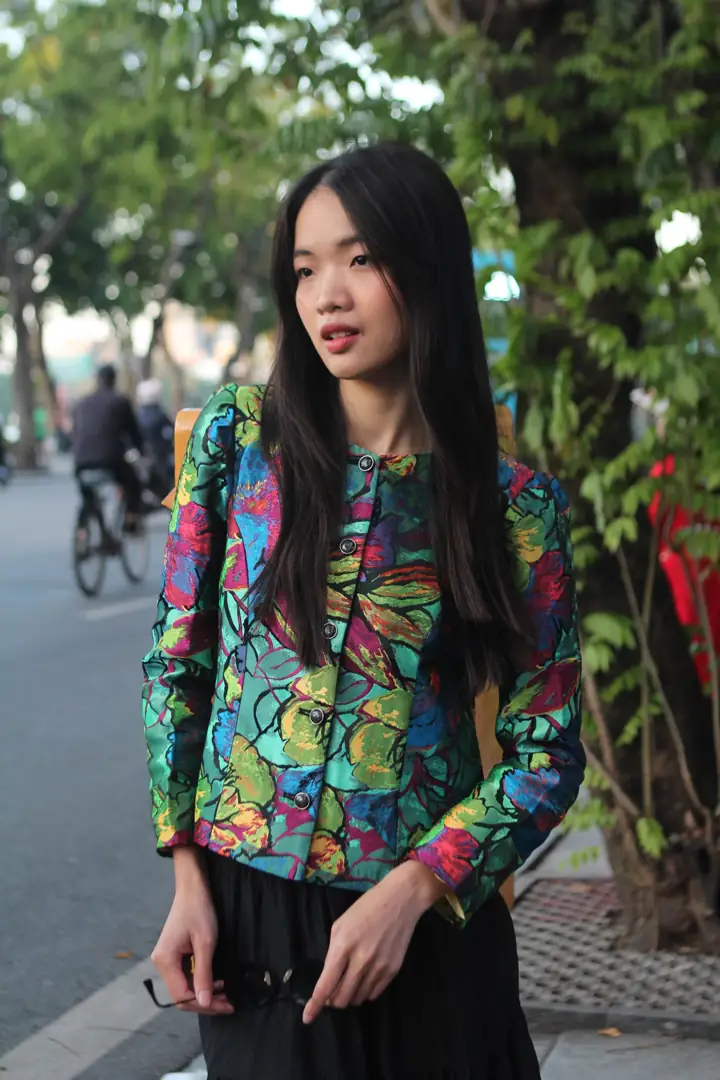 A fashion creator in a vivid editorial look on a city street
