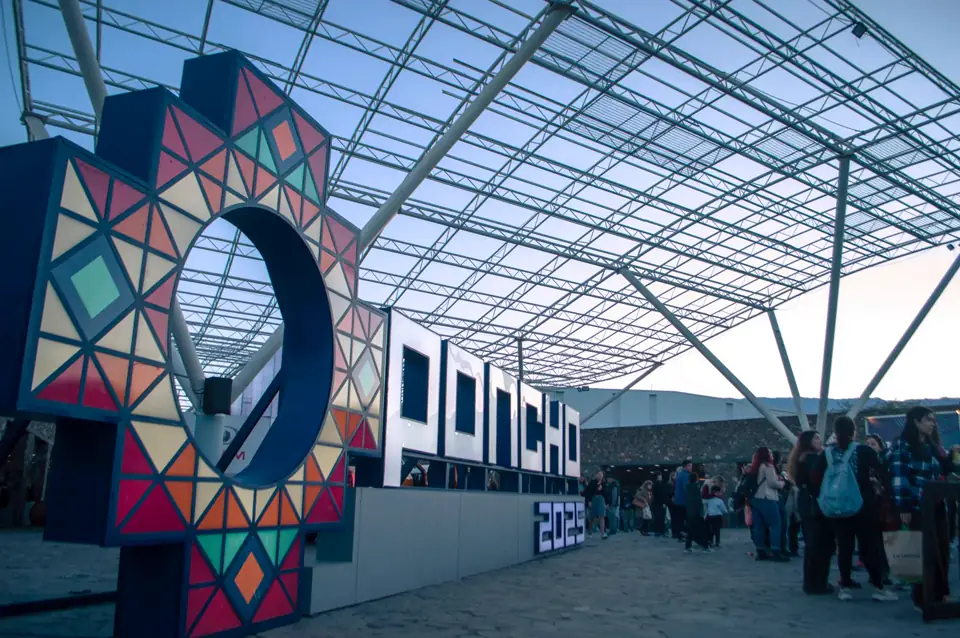 A colourful event installation with visitors moving through the space