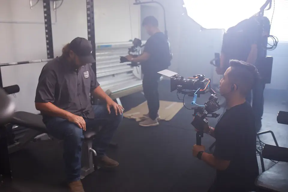 A production crew filming a campaign on a professional set